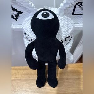 Black Plush Toy with Eye Design